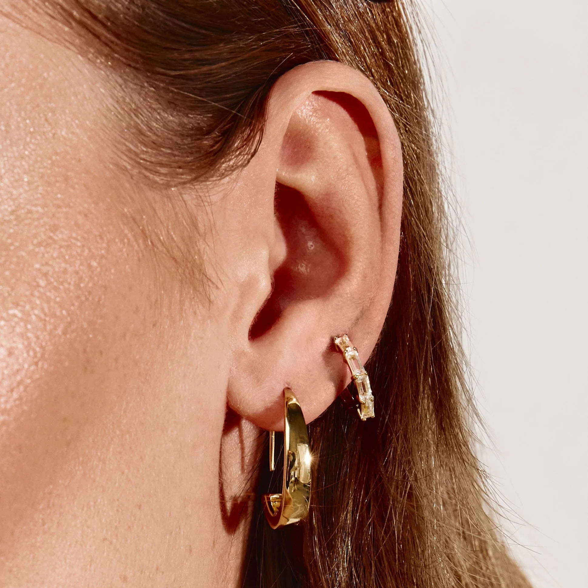 White Topaz Baguette Huggie Earrings in Gold